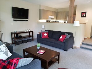 The kitchen overlooks the living room. The couch pulls out to a queen sofa bed.