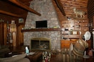 Great room with stone fireplace in house