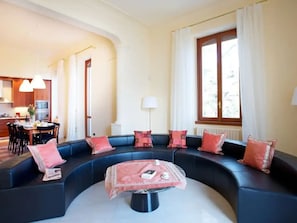 The living room enjoys enviable lake views and a stylish semi circle sofa.
