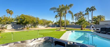 A view from the hot tub overlooking the pool and putting green.