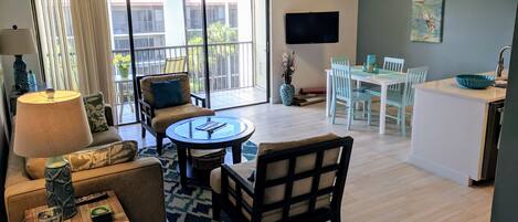 Entrance and living room and dining table.  Brand new tile floors.