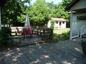 patio and back yard, plenty of seating with benches and extra chairs. 