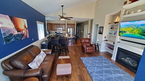 Great room has leather recliners, Smart TV, vaulted ceilings and fireplace
