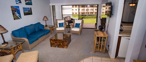 Living room looks out onto lanai. New carpet added during kitchen remodel.