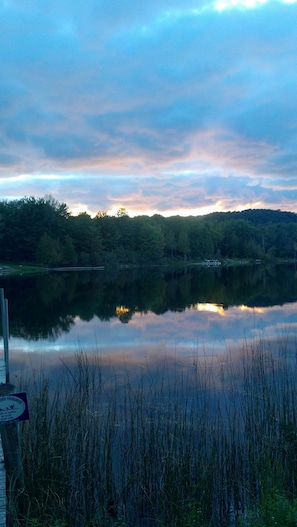 A guest looks out over the lake from her private bedroom deck