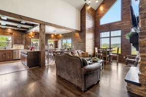 The living room has an open floor plan to the kitchen and dining room
