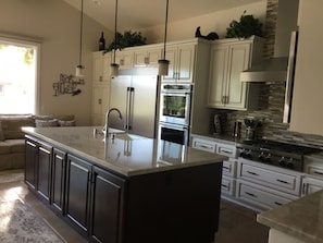 This brand new kitchen has all new KitchenAid appliances with a six burnerg 