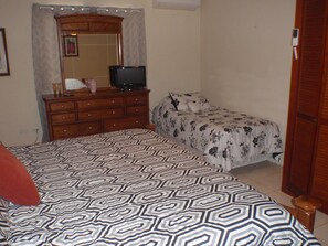 Twin Bed in the corner of the Master Bedroom.  TV  Too.