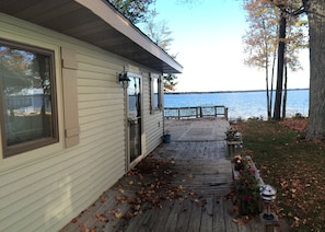 front door walkway to deck and lake view