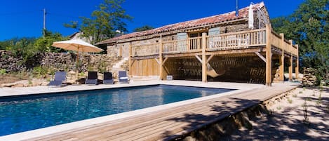 11x5m pool with large travertine bathing area, oak terrace and converted barn.