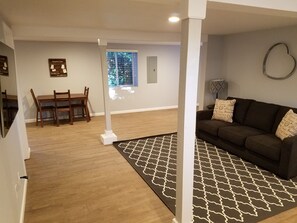 Large living room area with a queen size sofa bed. 