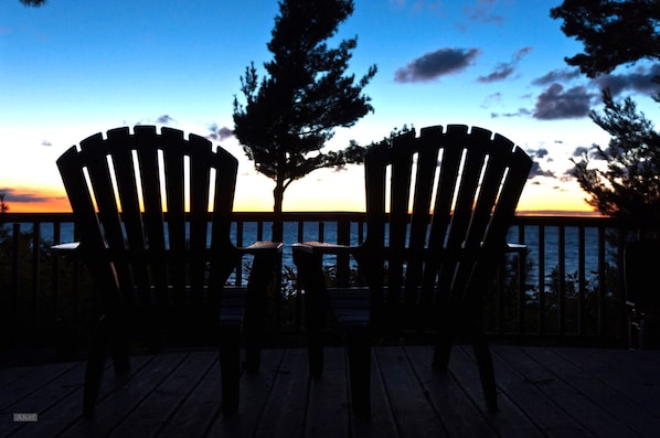 Chairs on the front deck on a bluebird day.
