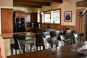 Spacious kitchen, breakfast bar and dining table that seats 10