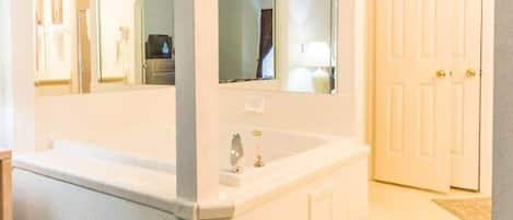 Master bedroom has an ensuite with a tub.