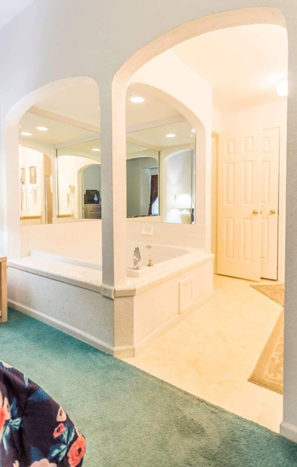 Master bedroom has an ensuite with a tub.