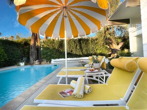 Lounge by the sparkling pool in the desert sunshine with lovely mountain views