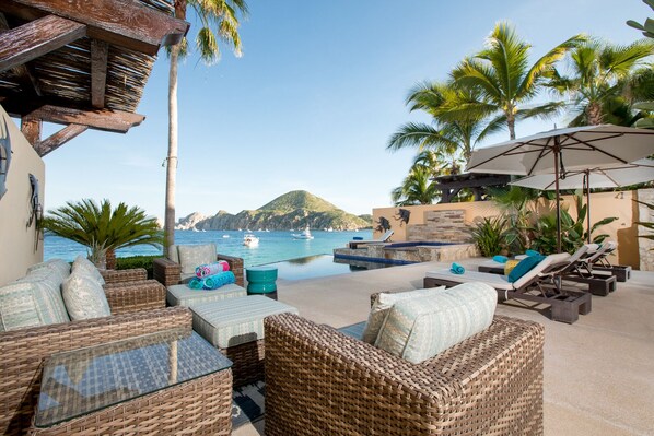 Spacious outdoor living area with comfy seating and loungers