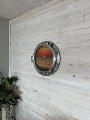 Shiplap wall with actual porthole in dining area. 