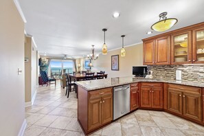 LARGE BREAKFAST BAR WITH A TV IN THE KITCHEN. OPEN SPACE TO SEE OCEAN VIEWS.  