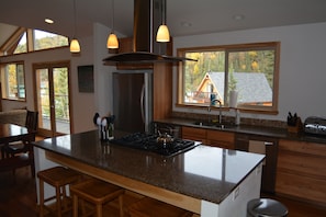 Commercial stovetop, two dishwashers and a double oven.