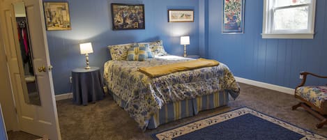 Bedroom with queen bed and walk-in closet, ceiling fan