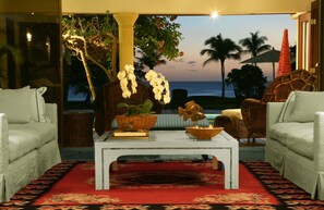 Living room at dusk, with the ocean behind