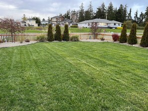 The huge fenced front yard offers a fun place for lawn games.