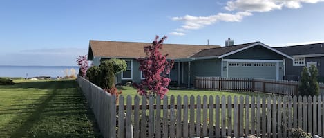 Front of house has a fenced yard that's ideal for kids and lawn games!