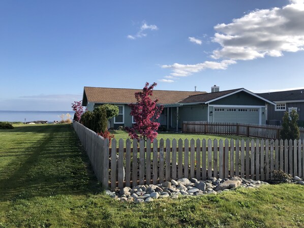 Front of house has a fenced yard that's ideal for kids and lawn games!
