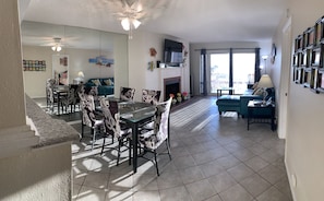 Dining & Living Room with 55" TV with balcony overlooking pool deck & ocean