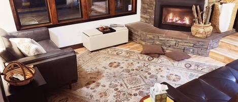 Living room with big windows, gas fireplace and new leather couches!!  