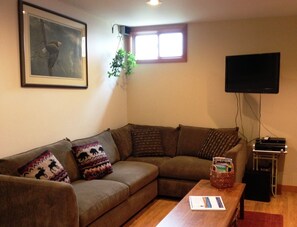 Sectional and flat screen television with Direct TV as provider.  