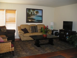 Living room that leads to kitchen and dining area.