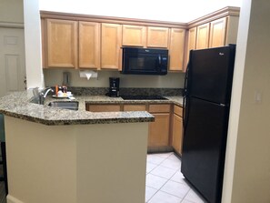 Fully equipped kitchen w/ full fridge, cooktop, convection microwave, dishwasher