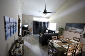 Spacious living space with vaulted ceiling and 70 inch remote controlled fan