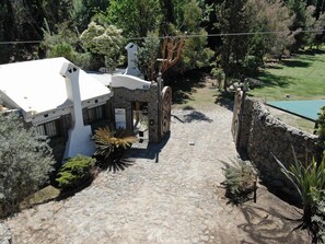 Property entrance and main villa to the left of the gate