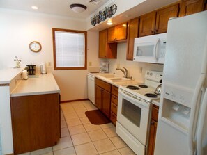 Kitchen with side-by-side refrigerator and all appliances.
