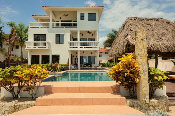 Rear view of pool, poop lounge palapa, and villa. (beach view)