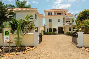 Front entrance, masonry fence, and gate.