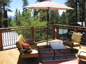 Comfy furniture with two large umbrellas. 