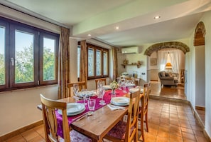 Dining room (air conditioner visible on wall near ceiling.) Seats up to 10.