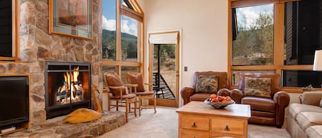 Great room, 17 Foot rock fireplace, mountain views. Large TV now above fireplace