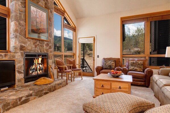 Great room, 17 Foot rock fireplace, mountain views. Large TV now above fireplace