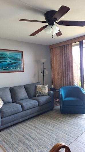 Livingroom area with high-quality pull-out queen sofa and swivel chair.