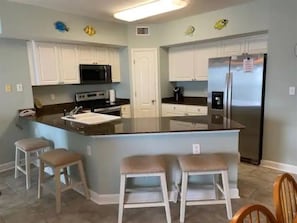 Kitchen area includes range, microwave, dishwasher, fridge with ice maker, keurig pod coffee pot and a drip style coffee pot