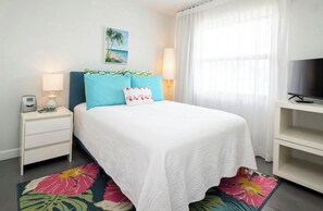Guest bedroom with full bed and smart TV.