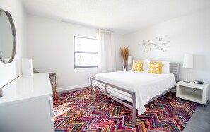 Guest bedroom with queen bed and walk-in closet.