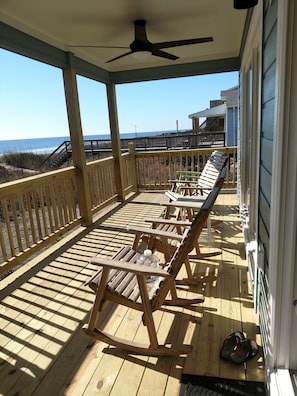 private porch with rocking chairs for beach viewing