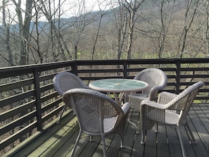 Outdoor deck seating overlooking creek, golf course,  and slopes