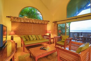 The living area has A/C, a flat screen TV, DVD/CD player, and comfy seating.
